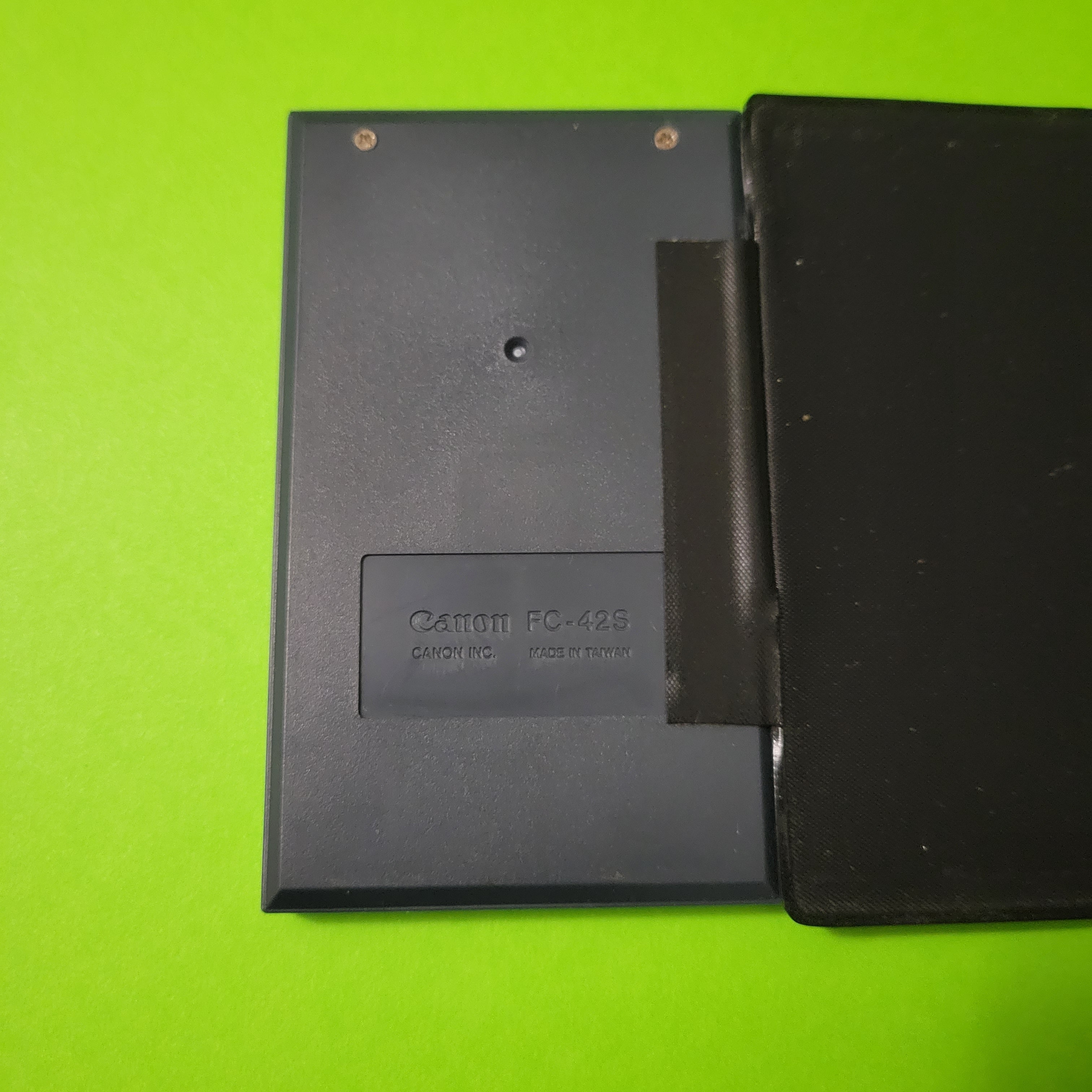 An image of the back of a Canon FC-42S four function plus calculator